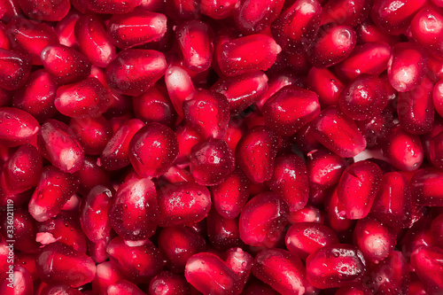 fresh pomegranate seeds macro close-up in drops