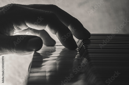 Photography Closeup of a hand playing piano, black and white