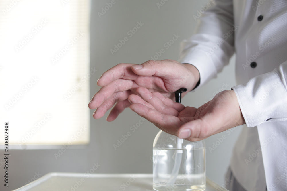 Washing hands by alcohol sanitizers or alcohol gel from pump bottle. Covid-19 corona virus outbreak infection prevention and control Washing hands by alcohol sanitizers or alcohol gel from pump bottle. Covid-19 corona virus outbreak infection prevention and control