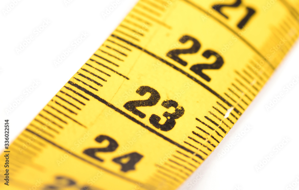 Close-up of a yellow measuring tape isolated on white - 23 Close-up of a yellow measuring tape isolated on white - 23