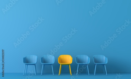 Bild auf Leinwand Yellow chair standing out from the crowd
