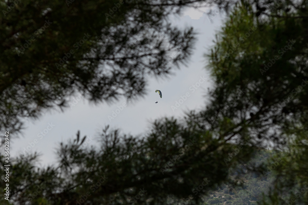 Man flying with parachute in the sky