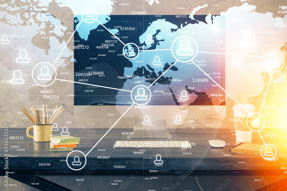 Computer on desktop with social network theme icon. Multi exposure. Concept of international connections. Computer on desktop with social network theme icon. Multi exposure. Concept of international connections.