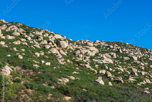 Small rocks on the mountain with clear blue sky photo