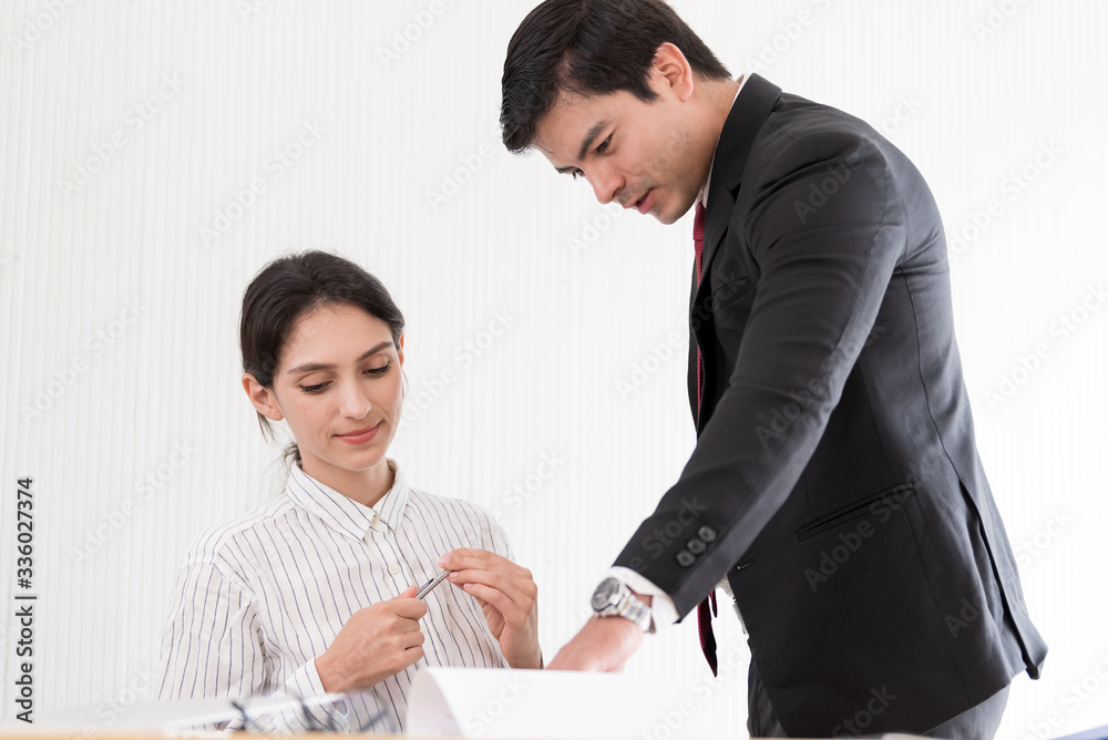 A manager and secretary working together in the office. A manager and secretary working together in the office.