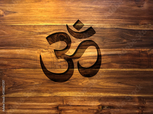om symbol on teak wood wall