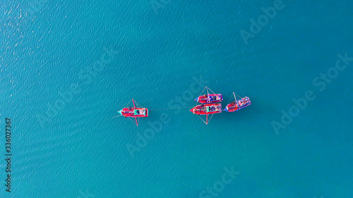 aerial of traditional fishing boats in turquoise water