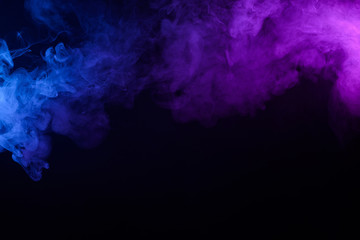 Colorful smoke or fog mist blue and purple border on black background