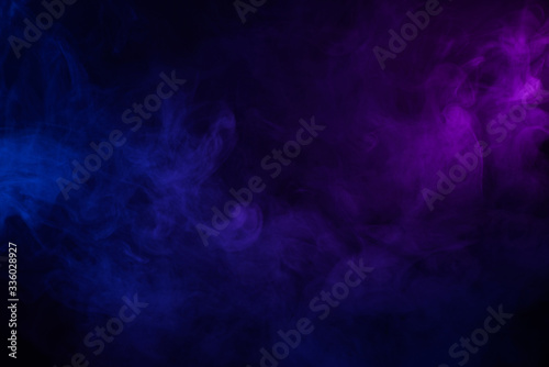 Soft clouds of colorful smoke dark abstract backgound photo