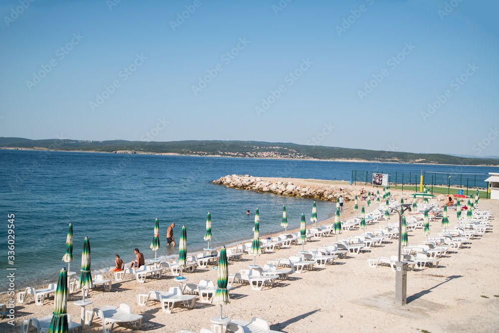 beach lounging on the sea. beach near the town of Crikvenica. the beginning of the tourist season. Vacation at sea. beach lounging on the sea. beach near the town of Crikvenica. the beginning of the tourist season. Vacation at sea.
