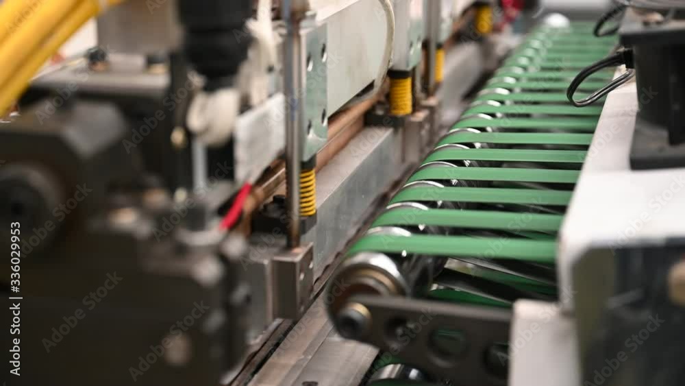 Close-up plastic bag cutting machine, seal kit and cutting knife are working to produce polypropylene bags in the concept of saving the world and the environment.