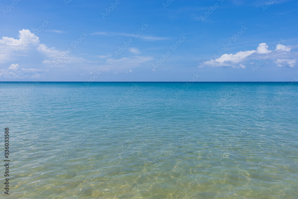Clear water sand beach and blue sky