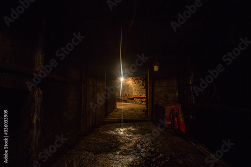 Underground gold quartz mine tunnel with light door
