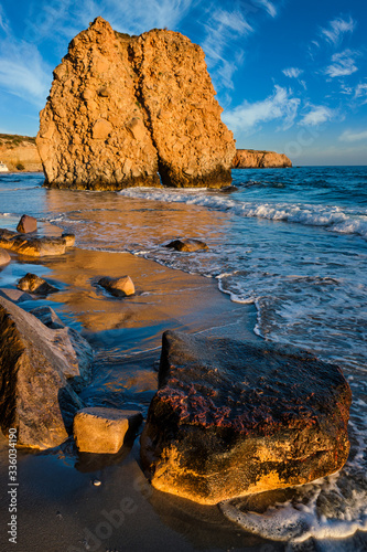 Fyriplaka beach and waves of Aegean sea on sunset, Milos island, Cyclades, Greece photo