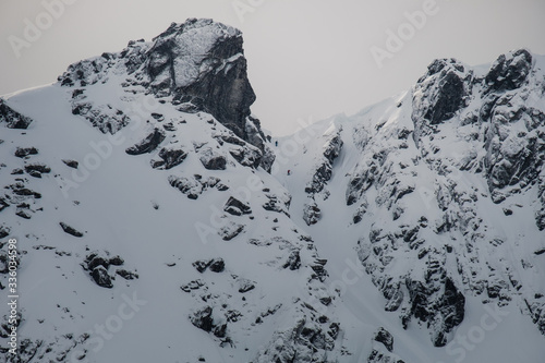 extreme skiing downhill wintersport, freeride skiing from a steep mountain. skialpinism is a popular sport in norway. picture taken by drone. photo