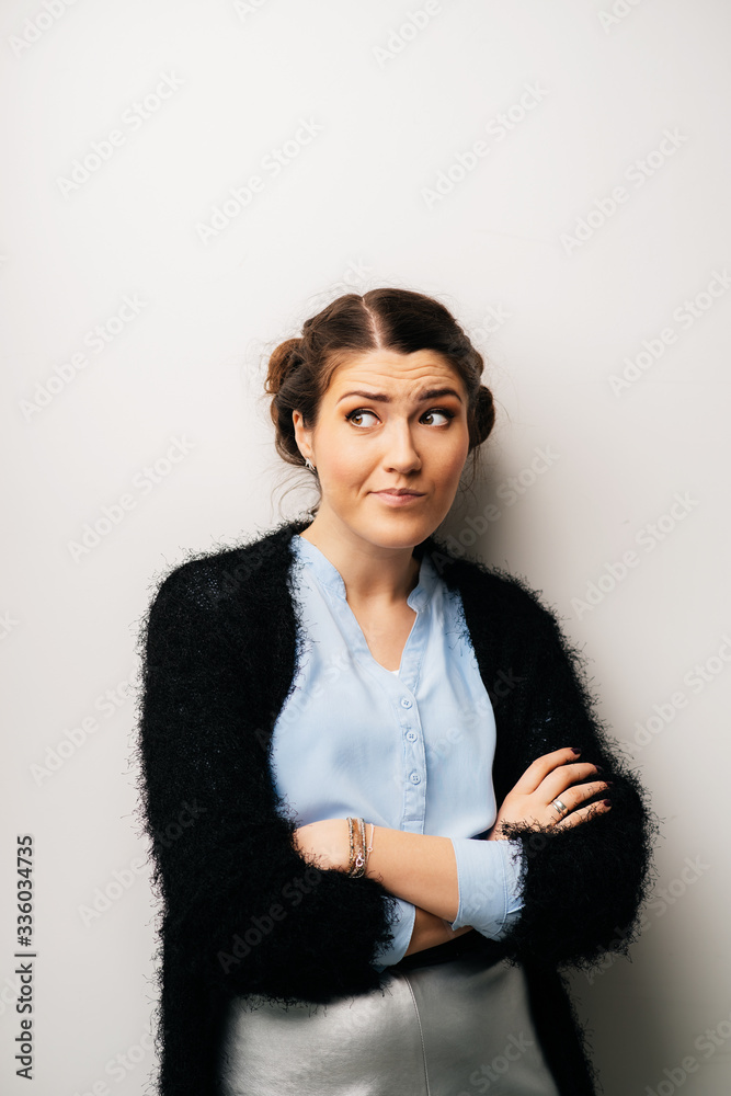 Woman crossed her arms thinks dissatisfied, angry, resentful. Isolated on a white background