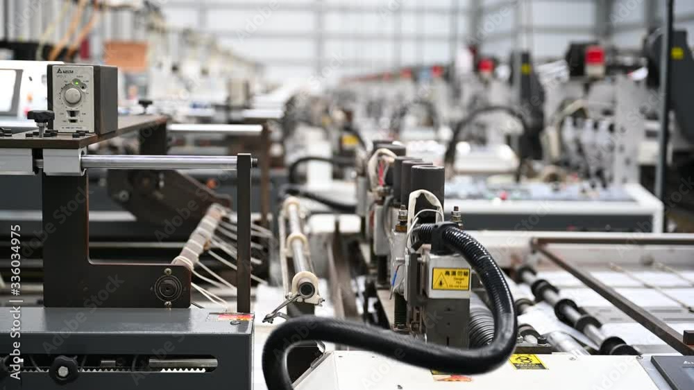 High speed plastic bag cutting machine working in factory Closeup that works non-stop in the concept of save the world and the environment.