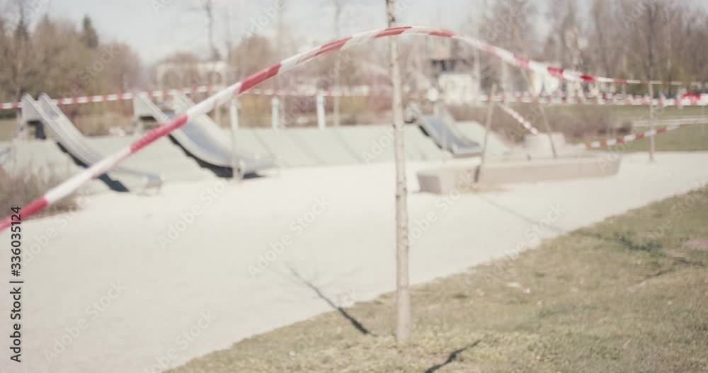 Empty children playground closed with warning tape in due to coronavirus covid 19 pandemic outbreak