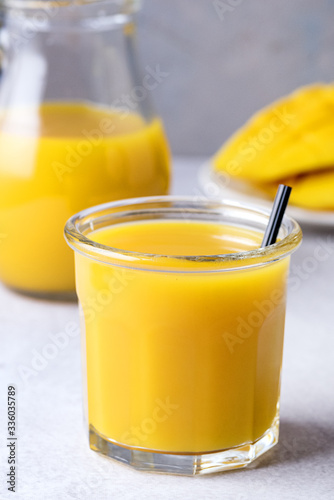 Glass of Tasty Mango Juice With Sliced and Whole Mango Fruit Healthy Drink Vertical