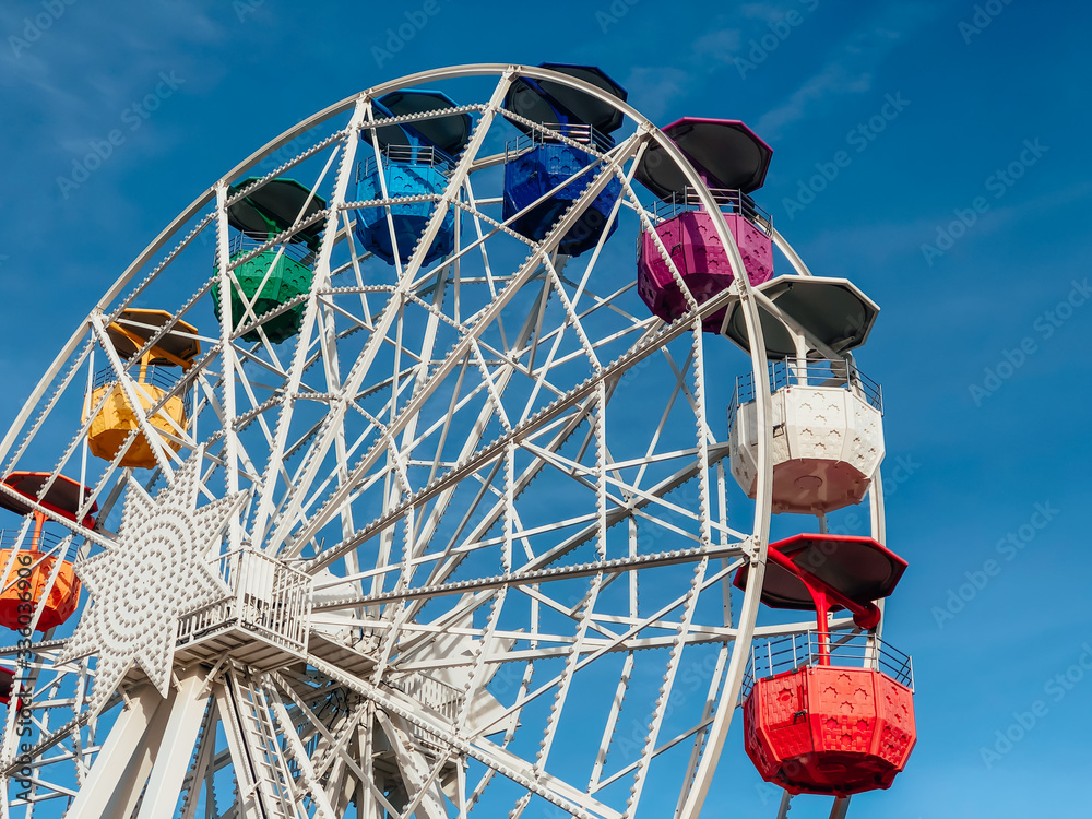 Amusement park, colorful ferris wheel. Side view. Amusement park, colorful ferris wheel. Side view.