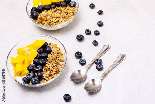 Bowls of Muesl and Yogurt with Berry and Mango Healthy Breakfast Diet Food Horizontal photo