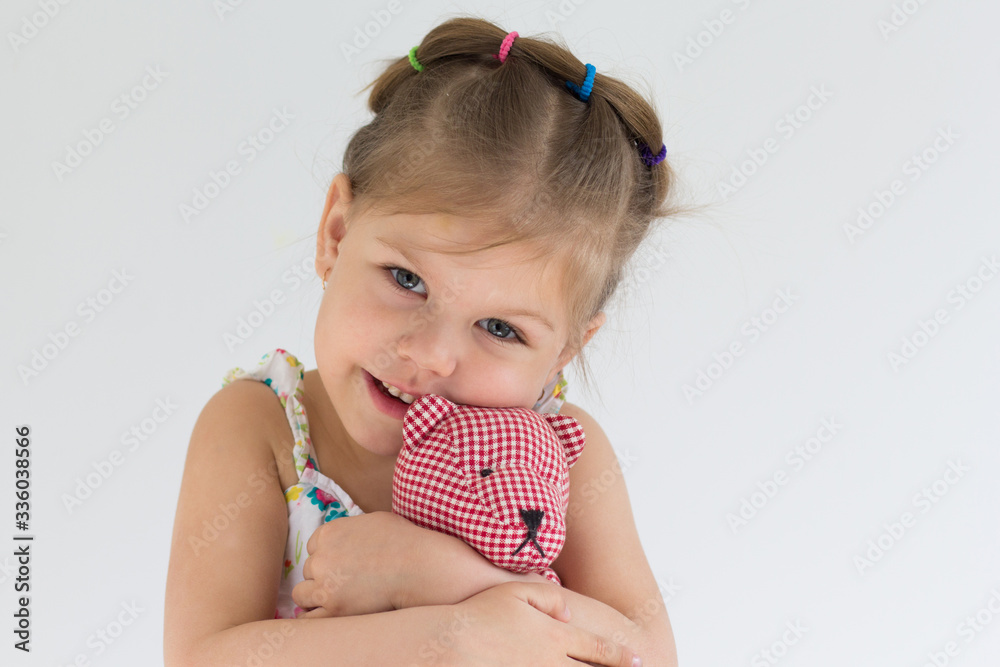 Portrait of caucasian child of three years old hugging toy bear on the white background Portrait of caucasian child of three years old hugging toy bear on the white background