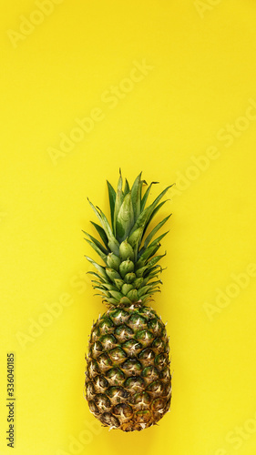 Front view of pineapple on yellow background  homemade juice