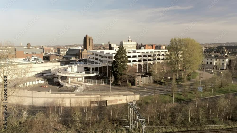Covid virus suburban town skyline lock down aerial view over quarantined British rail tracks and multi storey car park Covid virus suburban town skyline lock down aerial view over quarantined British rail tracks and multi storey car park