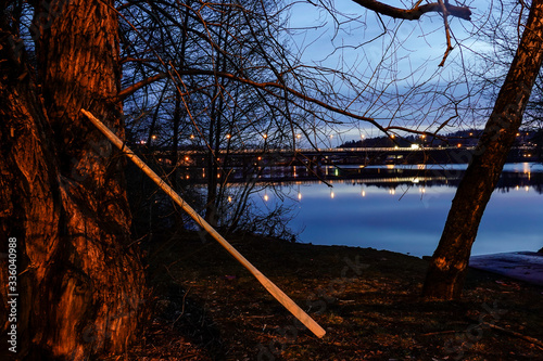 Stockholm, Sweden  Night landscape over Lake Mälaren looking towards Varby and the E4 highway, and oars for a rowing boat. © Alexander