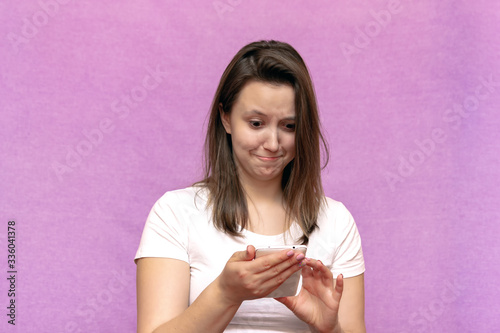portrait of emotional surprise and shocked girl looking at phone