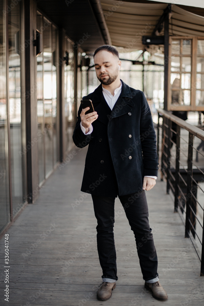 Portrait of fashionable well dressed man with beard posing outdoors Portrait of fashionable well dressed man with beard posing outdoors