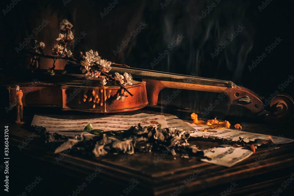 Old Violin, burning papers, notes melted candle wood on the background