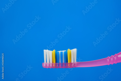 pink toothbrush on blue background