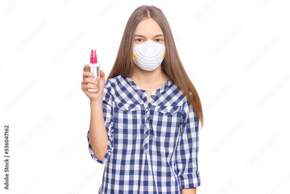 Concept of coronavirus quarantine. Child wearing medical protective mask with antibacterial antiseptic spray for hands disinfection during flu virus outbreak. COVID-19. Teen Girl isolated on white. Concept of coronavirus quarantine. Child wearing medical protective mask with antibacterial antiseptic spray for hands disinfection during flu virus outbreak. COVID-19. Teen Girl isolated on white.