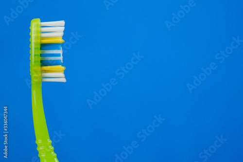 green toothbrush on blue background