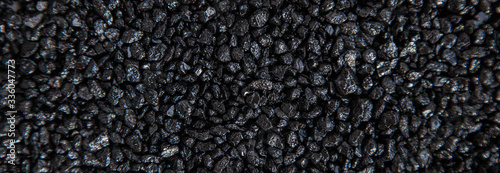 Many small black stones. Background, pattern, texture of small stones, gravel