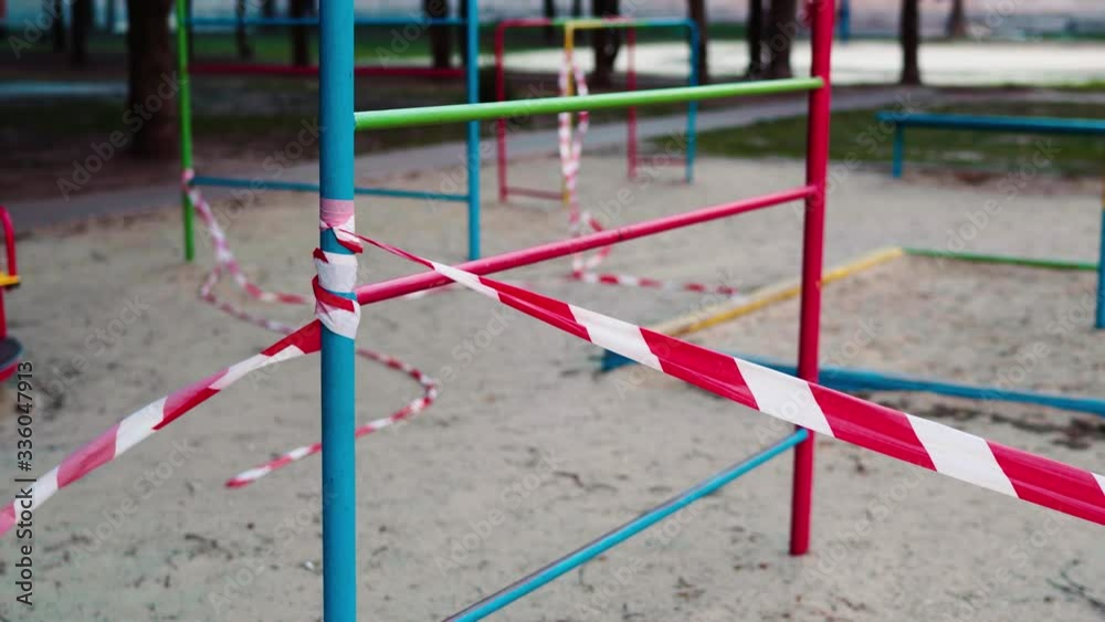 An empty abandoned playground fenced with ribbons in a residential area during quarantine due to the threat of AKA covid-19 coronavirus. Ukraine, Sumy An empty abandoned playground fenced with ribbons in a residential area during quarantine due to the threat of AKA covid-19 coronavirus. Ukraine, Sumy