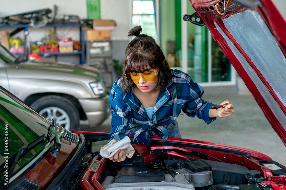 Asian young female car repair worker.