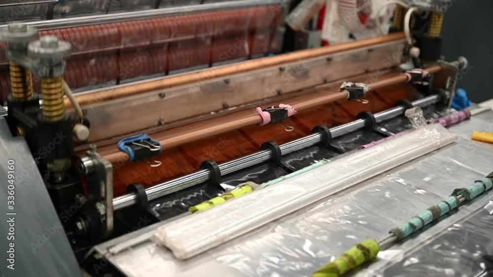 Close-up plastic bag cutting machine, seal kit and cutting knife are working to produce polypropylene bags in the concept of saving the world and the environment. Close-up plastic bag cutting machine, seal kit and cutting knife are working to produce polypropylene bags in the concept of saving the world and the environment.