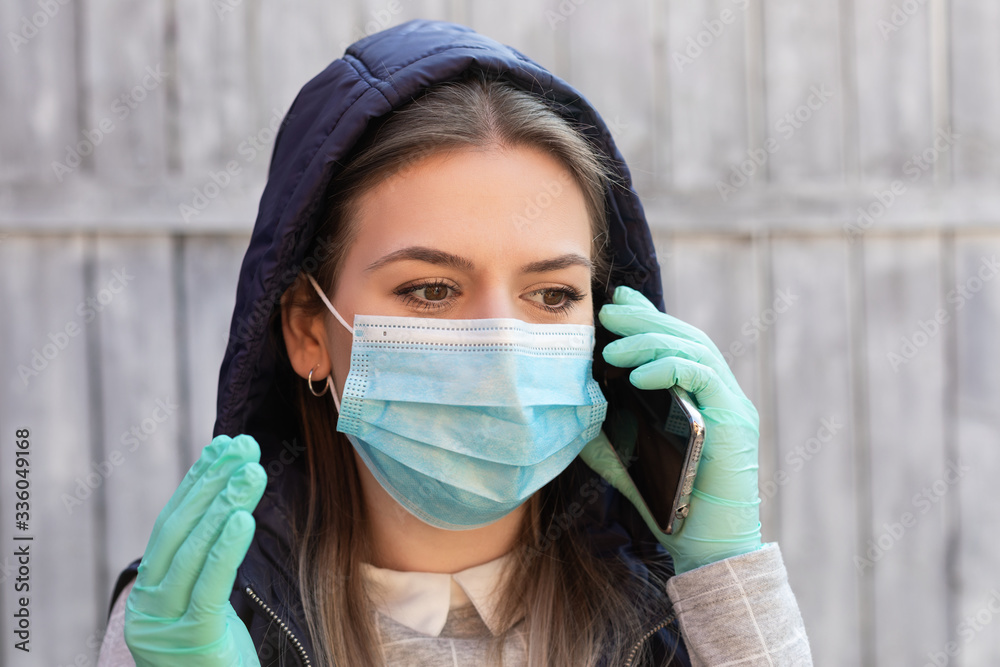 Woman with mask and gloves having a call