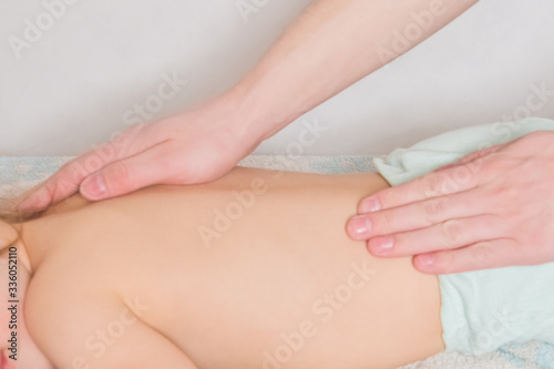 doctor has a child on the massage table on the procedure