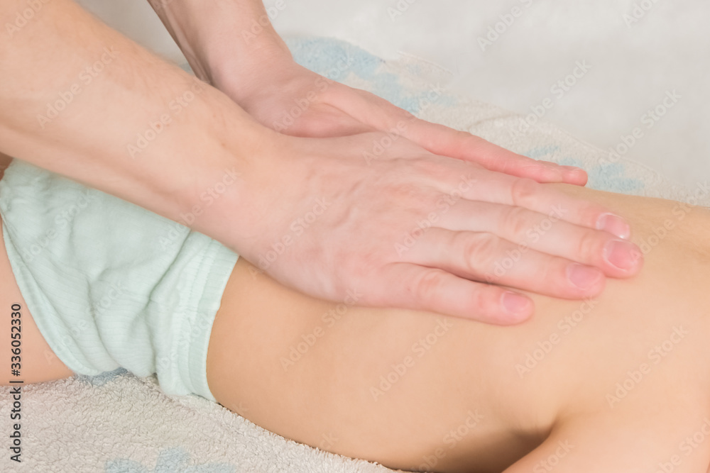 doctor has a child on the massage table on the procedure doctor has a child on the massage table on the procedure