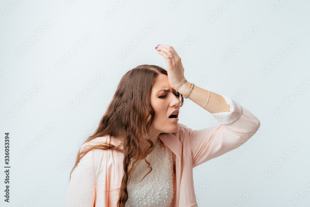 long-haired beautiful brunette girl made a mistake and holding his forehead long-haired beautiful brunette girl made a mistake and holding his forehead