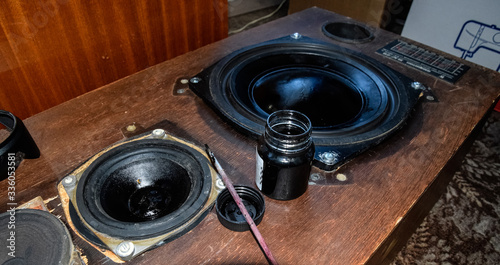 Ink and brush next to the speakers. Painting diffusers of speakers with stamp paint to give them aesthetics. photo