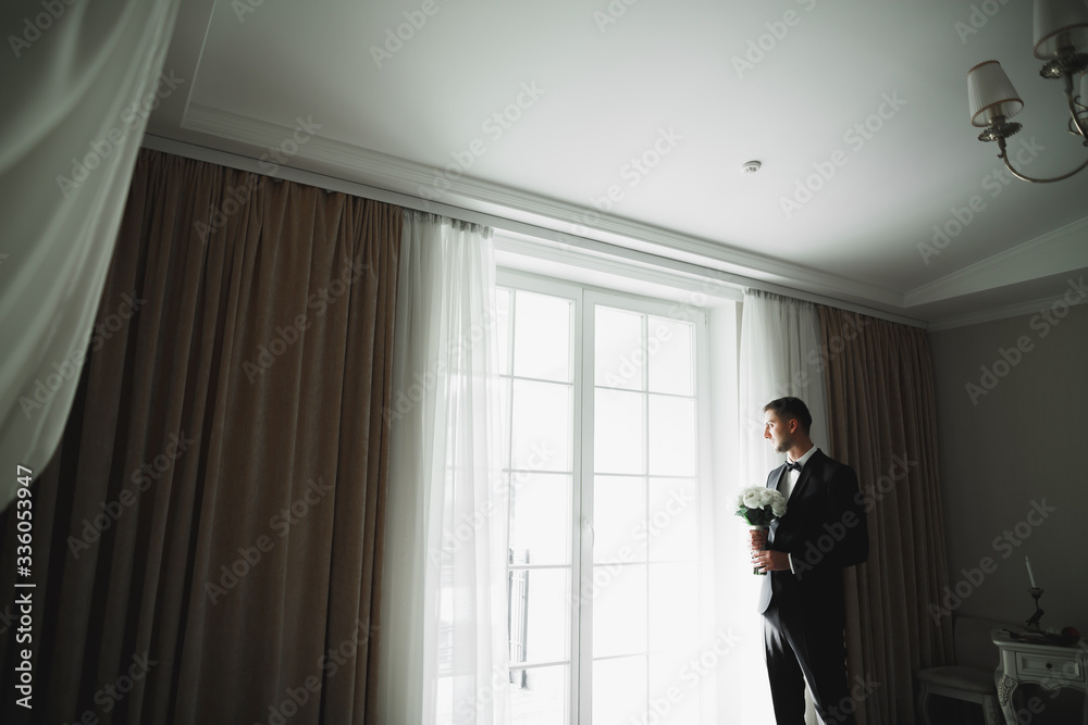 Young handsome man relaxing at his apartment in a hotel after business meeting Young handsome man relaxing at his apartment in a hotel after business meeting