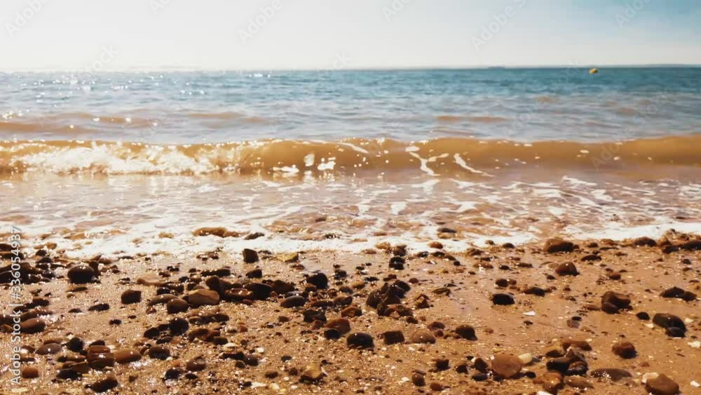 Waves gently washing over a golden sandy beach Waves gently washing over a golden sandy beach