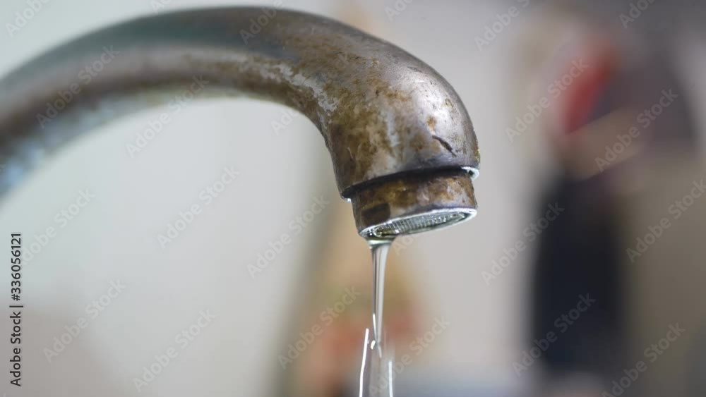 dripping old, rusty kitchen faucet. water dripping from a tap close up. Lack of clean water, reckless use of resources dripping old, rusty kitchen faucet. water dripping from a tap close up. Lack of clean water, reckless use of resources