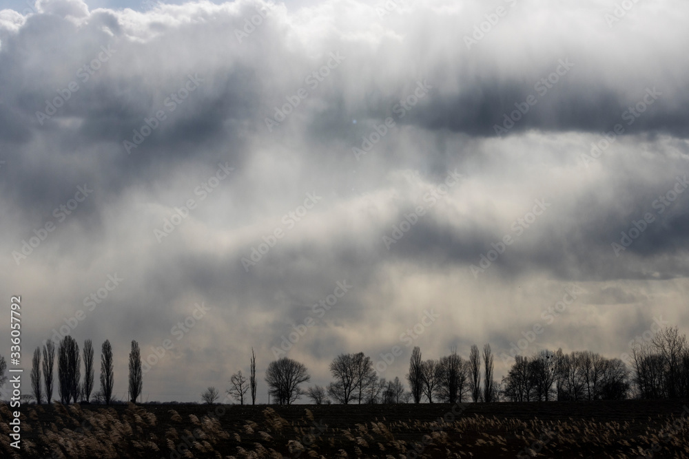 dark clouds against a dark landscape dark clouds against a dark landscape