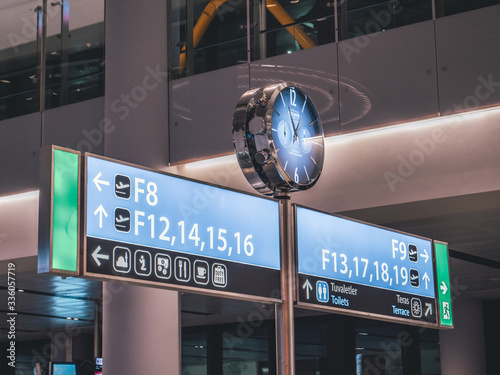 a sign with a clock at istanbul airport in turkey photo