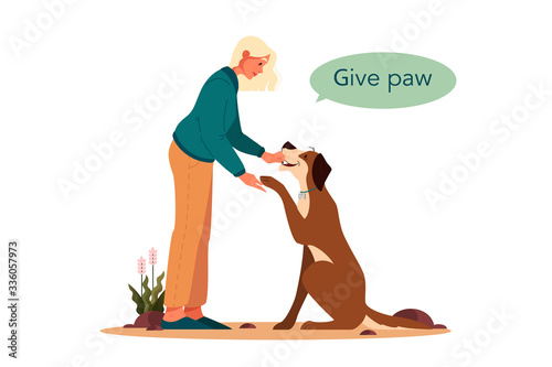 Woman training her pet dog. Happy puppy having command lesson.